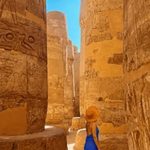 Traveler walking through Karnak Temple during a private Luxor day tour from Hurghada , Egypt