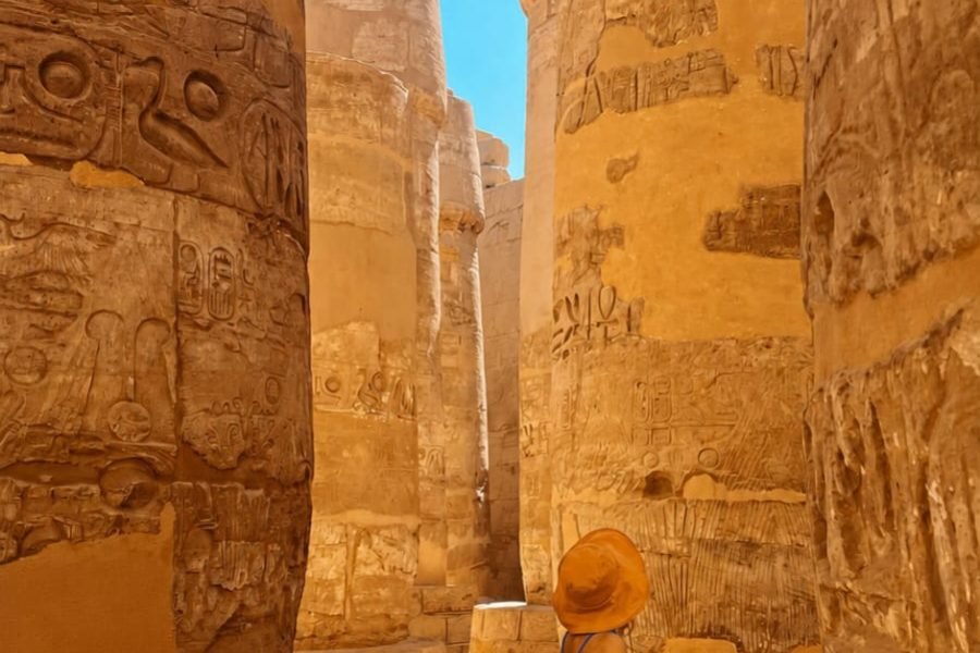 Traveler walking through Karnak Temple during a private Luxor day tour from Hurghada , Egypt
